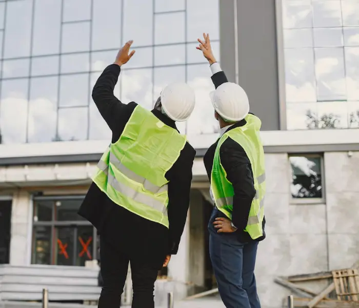 Commercial property maintenance team inspecting office building exterior